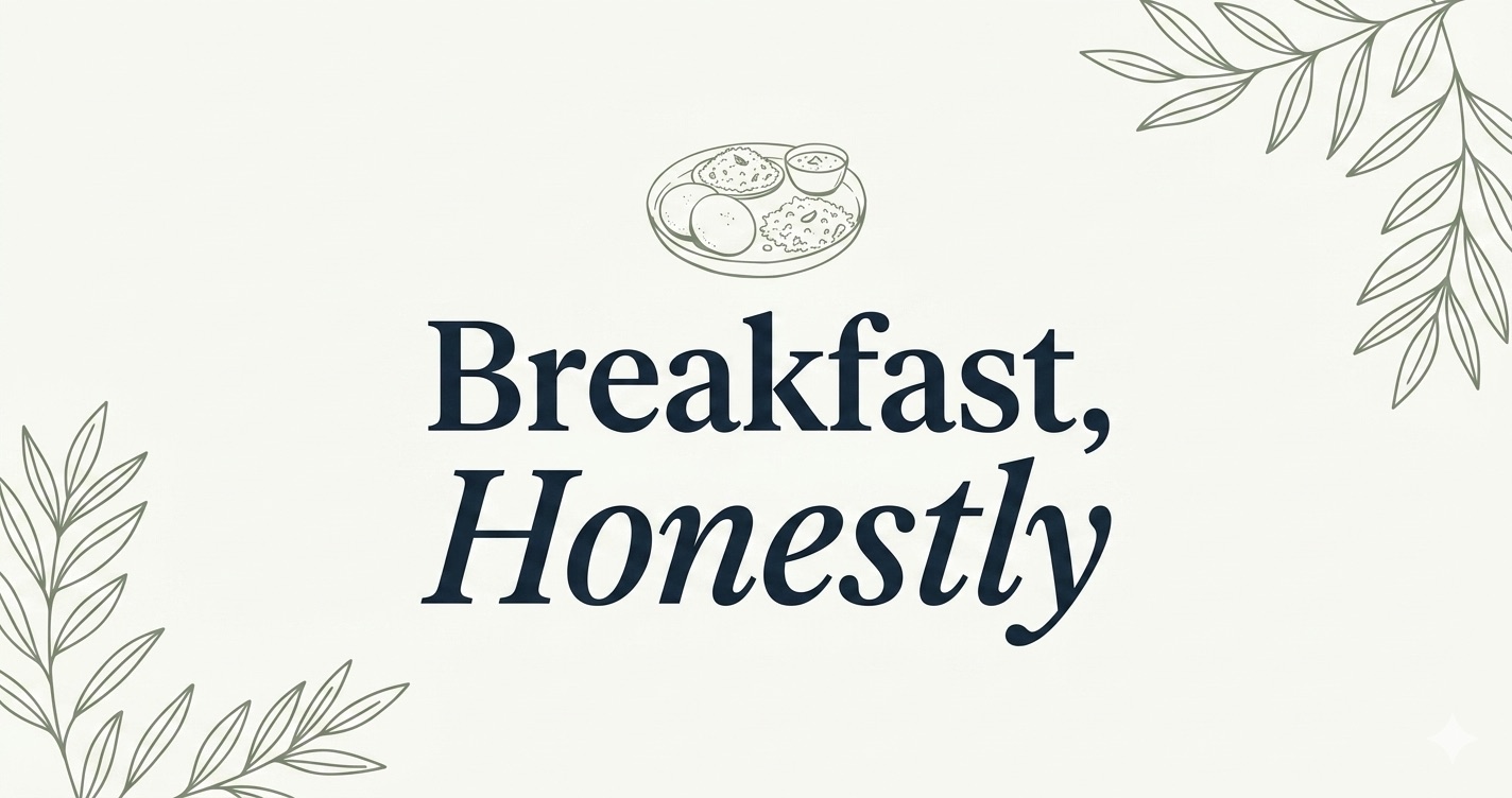 Cream-toned editorial cover with the words 'Breakfast, Honestly' in deep-ink serif, a small sage line drawing of an Indian breakfast thali and soft botanical corner accents.
